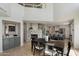 Bright open-concept dining area adjacent to the kitchen, with a stone fireplace feature at 10329 E Star Of The Desert Dr, Scottsdale, AZ 85255