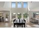 Bright and airy dining area with high ceilings, large windows, and modern decor at 10329 E Star Of The Desert Dr, Scottsdale, AZ 85255