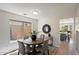 Cozy dining area with modern light fixture and views into kitchen at 10329 E Star Of The Desert Dr, Scottsdale, AZ 85255