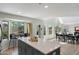 Bright, open kitchen features a gray island with breakfast bar seating and natural light at 10329 E Star Of The Desert Dr, Scottsdale, AZ 85255
