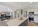 Bright, open kitchen featuring a gray island with white countertop and stainless steel appliances at 10329 E Star Of The Desert Dr, Scottsdale, AZ 85255