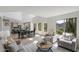 Bright open-concept living room featuring high ceilings, large windows, and modern decor at 10329 E Star Of The Desert Dr, Scottsdale, AZ 85255