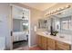 Main bathroom showcasing double sinks, wood cabinetry, and access to the main bedroom at 10329 E Star Of The Desert Dr, Scottsdale, AZ 85255