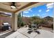 This covered patio has an outdoor kitchen and dining area to enjoy the outdoors at 10329 E Star Of The Desert Dr, Scottsdale, AZ 85255