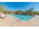 A beautiful community pool with lap lanes, lounge chairs, mountains and desert landscape at 10329 E Star Of The Desert Dr, Scottsdale, AZ 85255