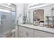 Bright bathroom featuring white cabinetry, marble countertops, and a glass-enclosed shower at 10951 E Delta Ave, Mesa, AZ 85208