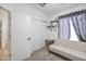 Bright bedroom features a cozy sofa, closet space, and ceiling fan, making it a comfortable retreat at 10951 E Delta Ave, Mesa, AZ 85208