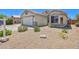 Charming home with a two-car garage, desert landscaping, and a cozy bay window at 10951 E Delta Ave, Mesa, AZ 85208