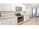 Modern kitchen featuring white cabinets, stainless steel appliances, and stylish countertops at 10951 E Delta Ave, Mesa, AZ 85208