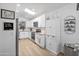 Well-lit kitchen with white cabinets, modern appliances, and a view of the dining area at 10951 E Delta Ave, Mesa, AZ 85208