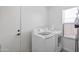 Bright laundry room with white washer and dryer, and natural light from the window at 10951 E Delta Ave, Mesa, AZ 85208