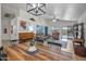 Open-concept living room with high ceilings, a piano, an abstract painting, and sliding glass doors to the backyard at 10951 E Delta Ave, Mesa, AZ 85208