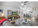 Bright living room with neutral colored furniture, a large television, and a combined dining area at 10951 E Delta Ave, Mesa, AZ 85208