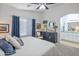 Main bedroom with white bedding, carpet flooring, accent furniture, ceiling fan and an attached bathroom at 10951 E Delta Ave, Mesa, AZ 85208