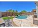 Backyard featuring a sparkling pool, palm trees, artificial grass, and patio furniture at 10951 E Delta Ave, Mesa, AZ 85208