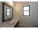 Stylish powder room featuring a vessel sink, modern faucet, and a picture window providing natural light at 13290 E La Junta Rd, Scottsdale, AZ 85255