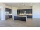Elegant kitchen featuring an island, sleek dark cabinetry, and stainless steel appliances at 13290 E La Junta Rd, Scottsdale, AZ 85255