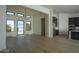 Bright, open-concept living room with wood floors, sleek black chandelier, and abundant natural light at 13290 E La Junta Rd, Scottsdale, AZ 85255