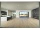 Spacious living area featuring wood floors, a fireplace, and an open layout into the kitchen at 13290 E La Junta Rd, Scottsdale, AZ 85255