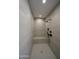 Modern shower with sleek tile, a built-in bench, and a rainfall shower head for a spa-like experience at 13290 E La Junta Rd, Scottsdale, AZ 85255