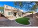 Private backyard with patio, artificial grass, and low-maintenance desert landscaping at 13585 N 87Th Dr, Peoria, AZ 85381
