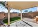 Cozy backyard patio with artificial turf, pavers, and a privacy wall, creating a tranquil outdoor space at 13585 N 87Th Dr, Peoria, AZ 85381