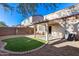 A delightful backyard has a covered patio, a cozy seating area, and an easy-care green patch at 13585 N 87Th Dr, Peoria, AZ 85381