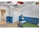 Bright bedroom showcasing a closet with sliding doors, shelving with books and a blue and white color scheme at 13585 N 87Th Dr, Peoria, AZ 85381