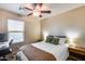 Bright bedroom with a ceiling fan, and desk area, offering comfort and functionality at 13585 N 87Th Dr, Peoria, AZ 85381