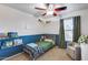 Colorful bedroom with a ceiling fan, chair and bookshelves, creating an ideal room at 13585 N 87Th Dr, Peoria, AZ 85381
