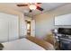 This bedroom features a ceiling fan, closet space, desk area, and provides access to the hallway at 13585 N 87Th Dr, Peoria, AZ 85381