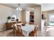 Charming dining room with wooden table, sliding glass doors and convenient access to the kitchen at 13585 N 87Th Dr, Peoria, AZ 85381