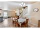 Open floor plan with dining area adjacent to the living room and staircase at 13585 N 87Th Dr, Peoria, AZ 85381