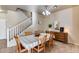 Inviting dining room featuring a staircase and a traditional wooden table and chairs at 13585 N 87Th Dr, Peoria, AZ 85381