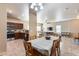Well-lit dining area open to the kitchen and living room, promoting seamless entertaining at 13585 N 87Th Dr, Peoria, AZ 85381