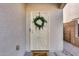 Inviting front door with charming wreath and 'Home Sweet Home' welcome mat at 13585 N 87Th Dr, Peoria, AZ 85381