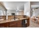 Kitchen sink area with granite counters and open to the dining and living areas at 13585 N 87Th Dr, Peoria, AZ 85381