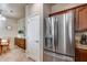 Close-up of a modern stainless steel refrigerator in an open-concept kitchen at 13585 N 87Th Dr, Peoria, AZ 85381