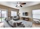 Inviting living room with modern ceiling fan, plush seating, and natural light at 13585 N 87Th Dr, Peoria, AZ 85381