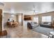 Bright and open living room with tile floors, comfortable seating, and an adjacent dining area at 13585 N 87Th Dr, Peoria, AZ 85381