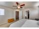 Comfortable main bedroom with a view of a closet, a ceiling fan and neutral walls at 13585 N 87Th Dr, Peoria, AZ 85381