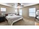 Spacious main bedroom with plush carpeting, a ceiling fan and multiple windows providing ample natural light at 13585 N 87Th Dr, Peoria, AZ 85381