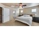 Inviting main bedroom featuring soft lighting, a ceiling fan, and an ensuite bathroom at 13585 N 87Th Dr, Peoria, AZ 85381