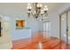 Open concept dining room with hardwood floors, elegant chandelier, and seamless flow to the kitchen at 14850 E Grandview Dr # 138, Fountain Hills, AZ 85268
