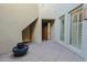 Welcoming entryway with tiled floors, a wooden front door, and a potted plant at 14850 E Grandview Dr # 138, Fountain Hills, AZ 85268