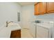 Well-equipped laundry room with sink, cabinets, washer and dryer at 14850 E Grandview Dr # 138, Fountain Hills, AZ 85268