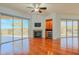 Cozy living room with fireplace, built-in shelving, wine cooler, and sliding glass doors to the patio at 14850 E Grandview Dr # 138, Fountain Hills, AZ 85268
