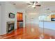 Spacious living room with hardwood floors, fireplace, and built-in bar, perfect for entertaining guests at 14850 E Grandview Dr # 138, Fountain Hills, AZ 85268