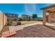 This backyard features an outdoor covered patio and landscaped lawn, offering a perfect outdoor retreat at 15105 W Glenrosa Ave, Goodyear, AZ 85395