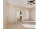This primary bedroom features neutral walls and carpet, with a ceiling fan and access to the ensuite bathroom at 15105 W Glenrosa Ave, Goodyear, AZ 85395